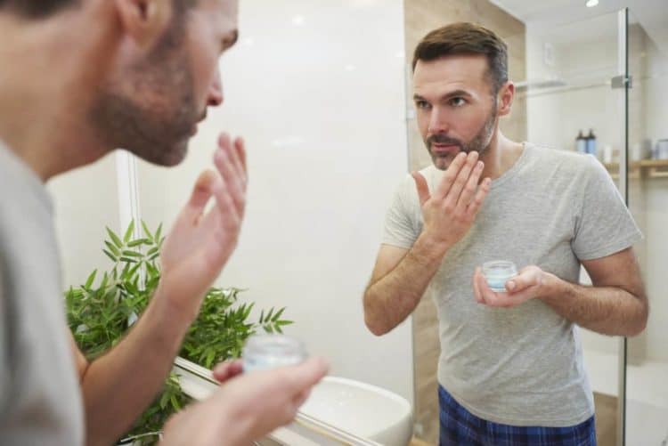 Man applying beard balm conditioner to help stop itch