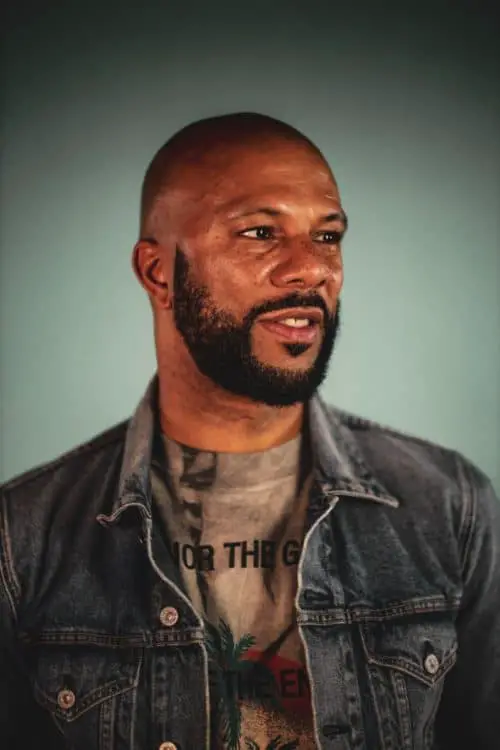 Common showing off his casual style and a bald head.
