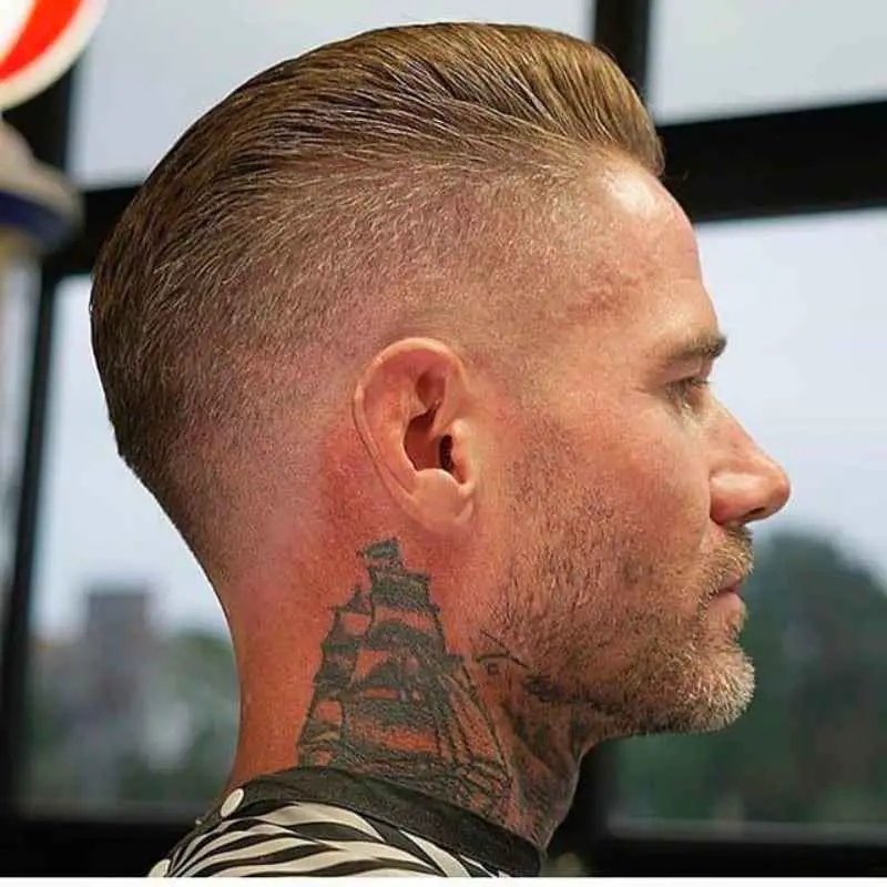 The clean fade crew cut can be paired with a stubble beard