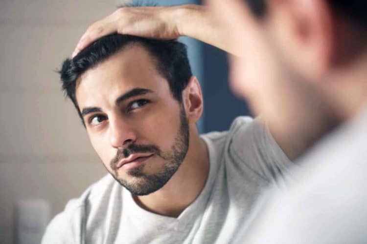 Man Worried For Alopecia Checking Hair For Loss and receding hairline