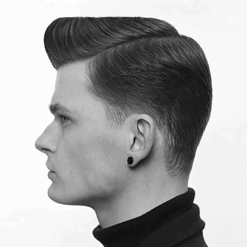 Taper fade haircut with a side part